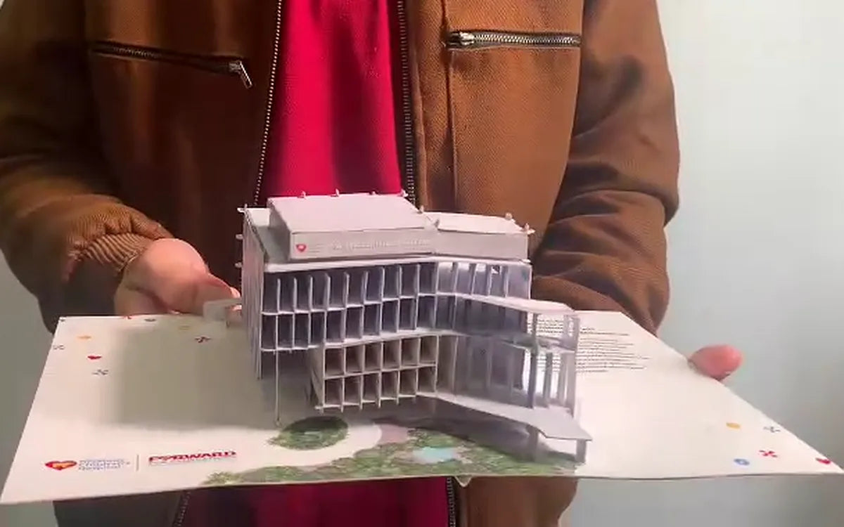 A WOW Paper Art pop-up card opened into a detailed 3D paper building sculpture